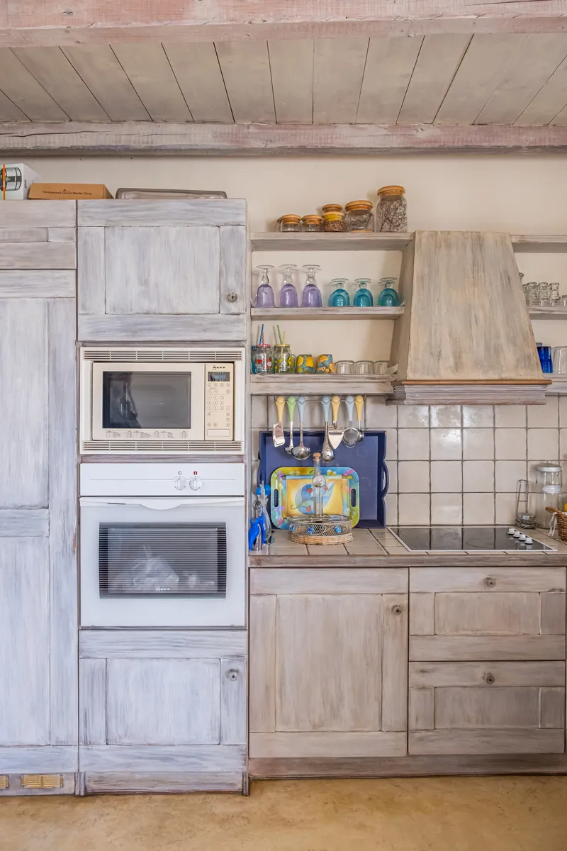 Kitchen detail showing storage, sink, and natural light from the window