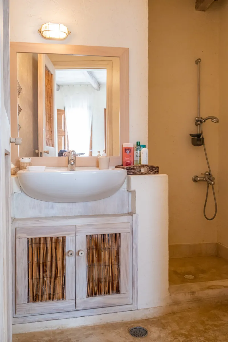 Master en-suite bathroom with large shower and stone basin