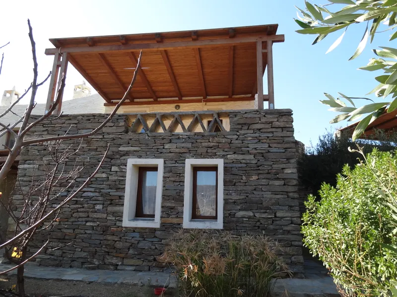 Outdoor stone patio beside the master bedroom with Aegean view